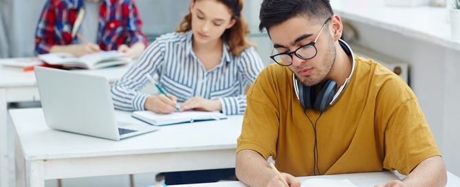 Students sit at desks in class