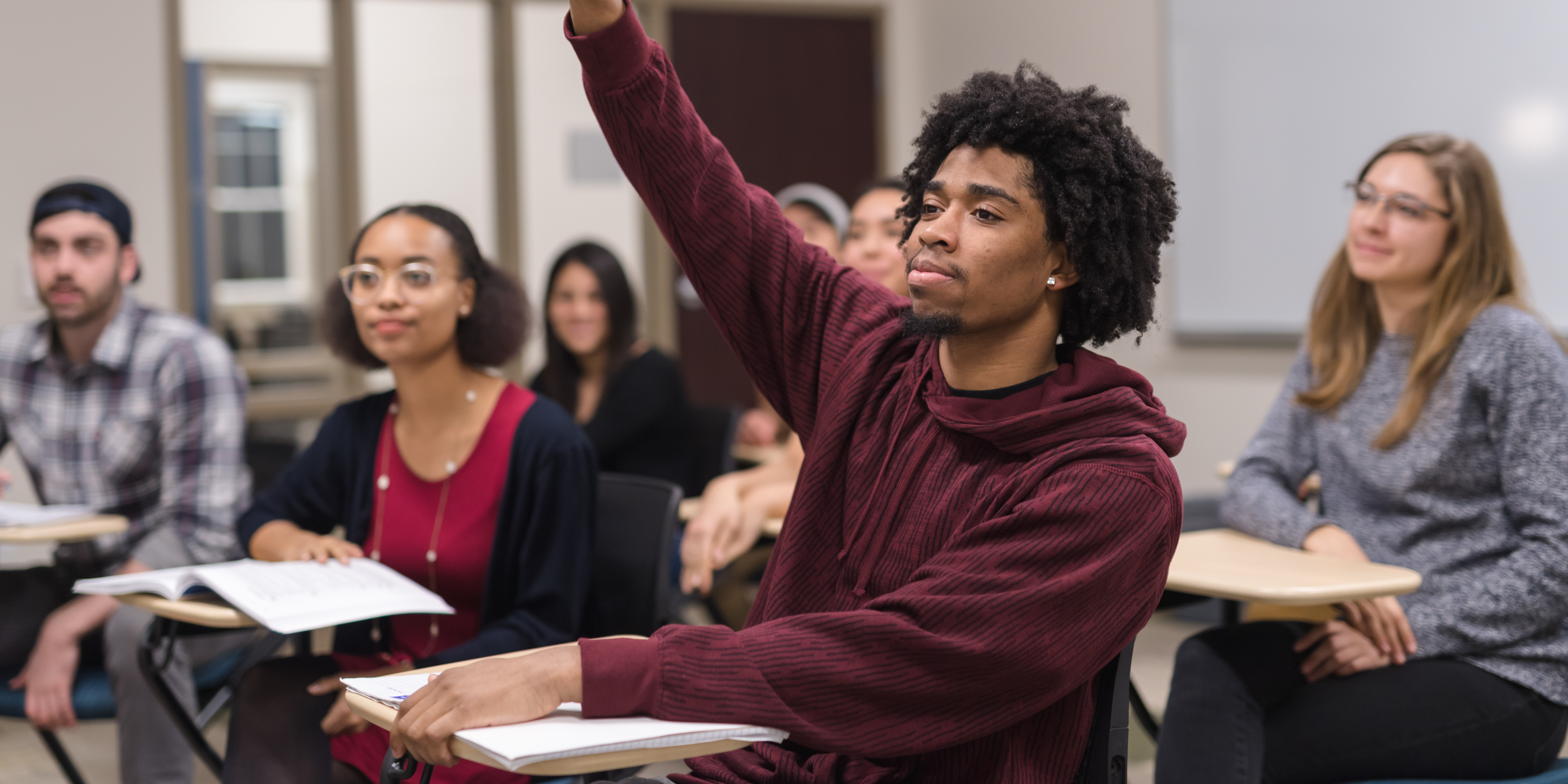 A student raises his hand in class