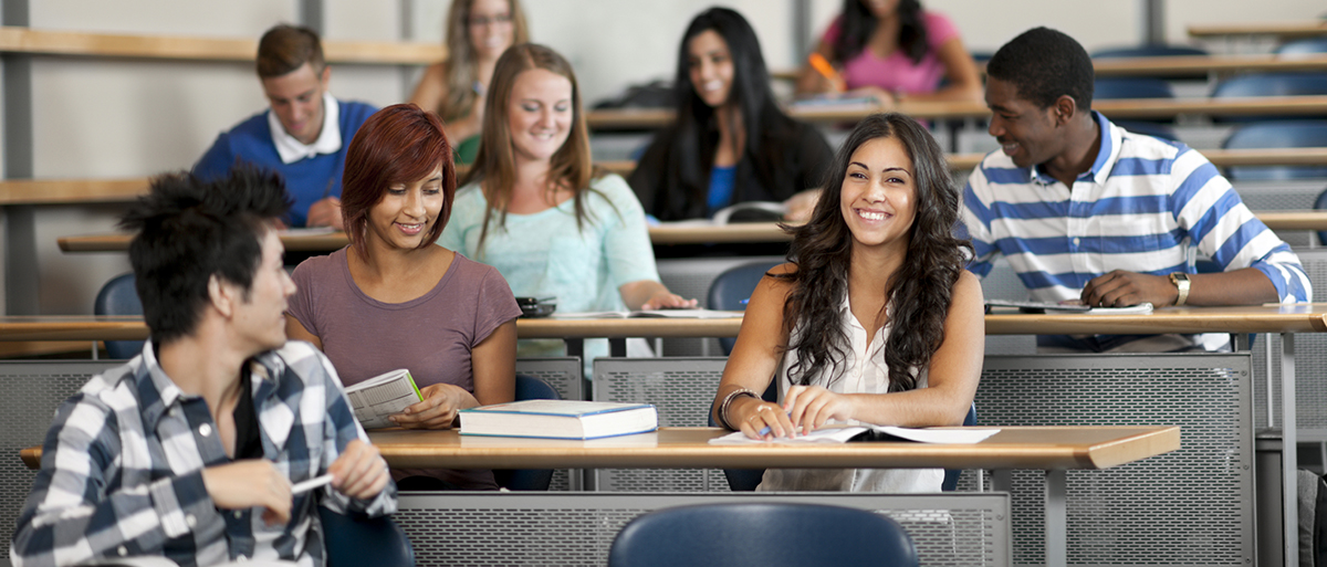 Students happily chatting in a college lecture hall