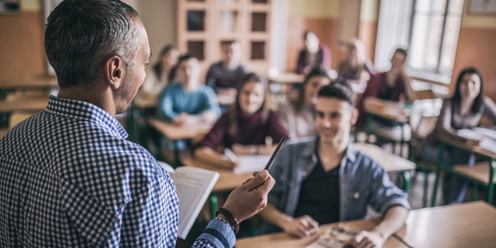 A teacher at the front of the classroom