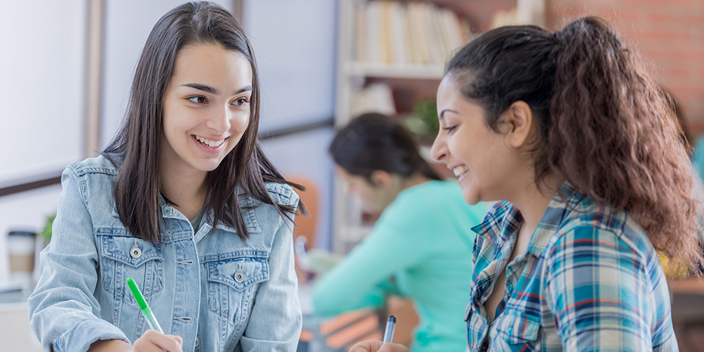 Happy college students work together in the student center