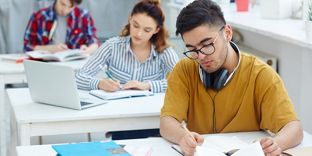 Students sit at desks in class