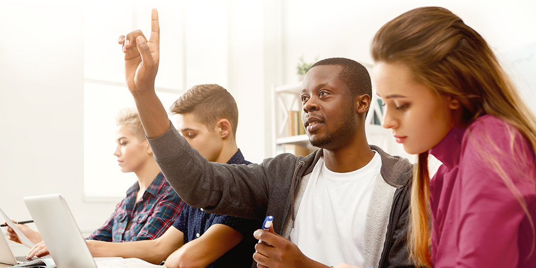 A student raises his hand in class