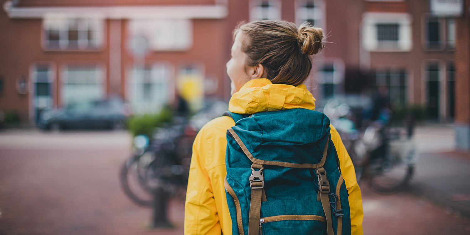 A student carries a backpack on campus