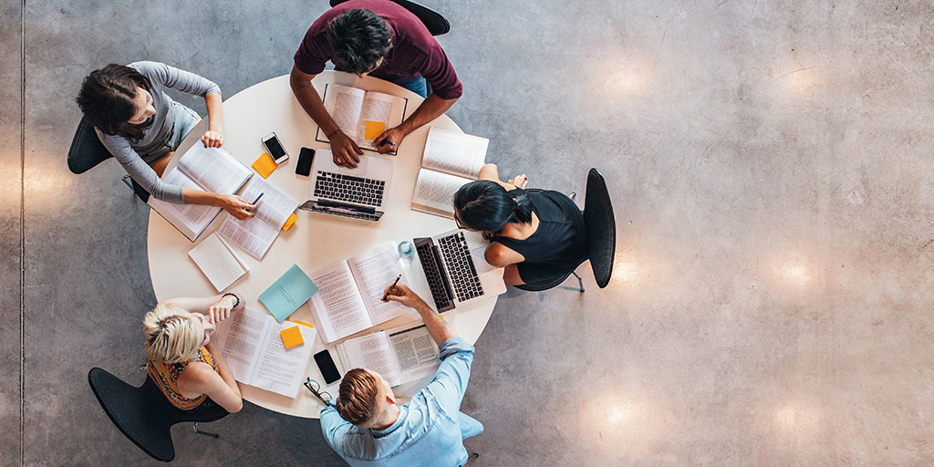 An overhead view of college students studying together