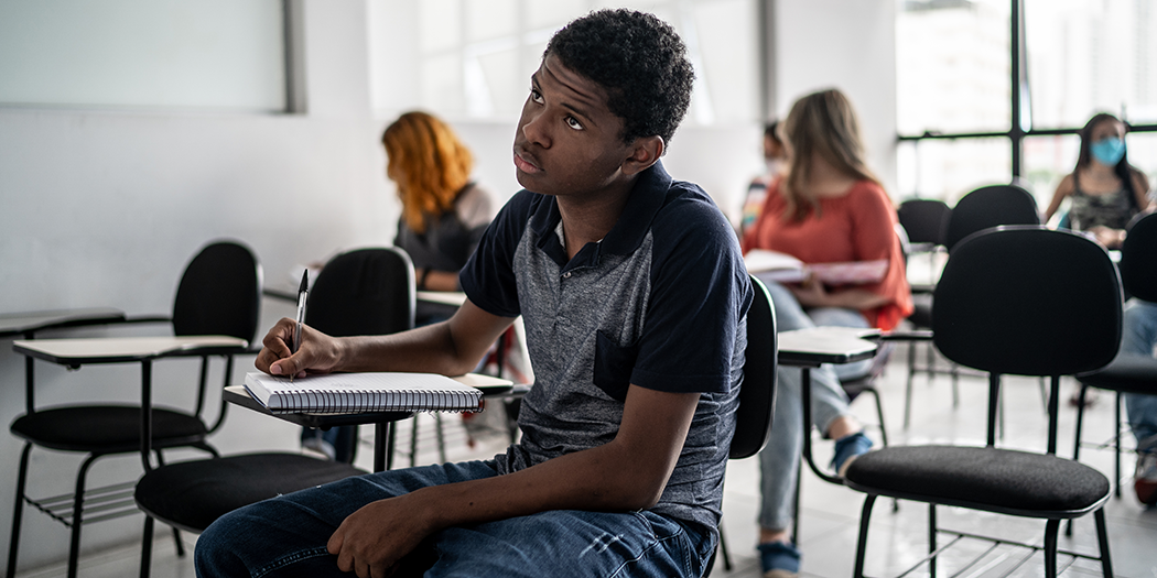 A student takes notes in class