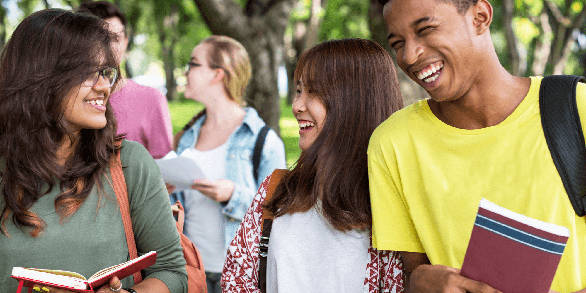 Students on campus walking and laughing.