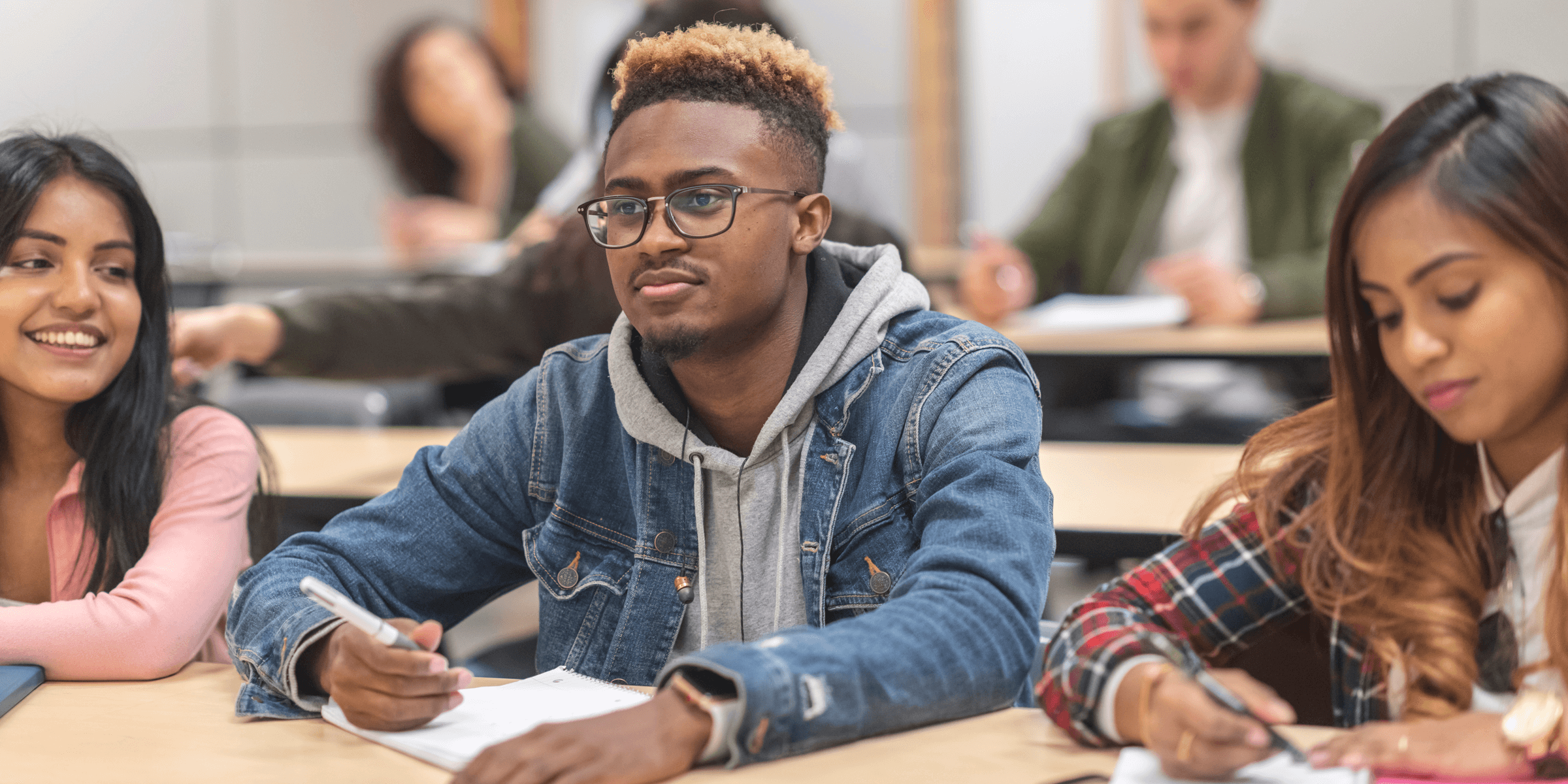 Three students listening to instructor in class.