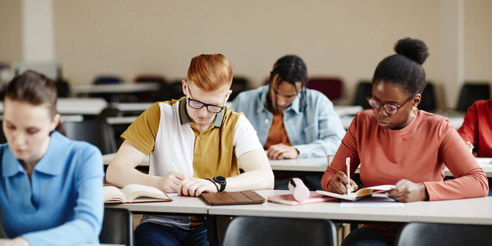 students take test in college classroom