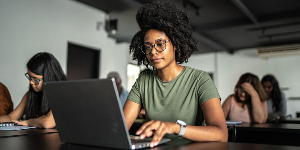 Woman gazes at laptop