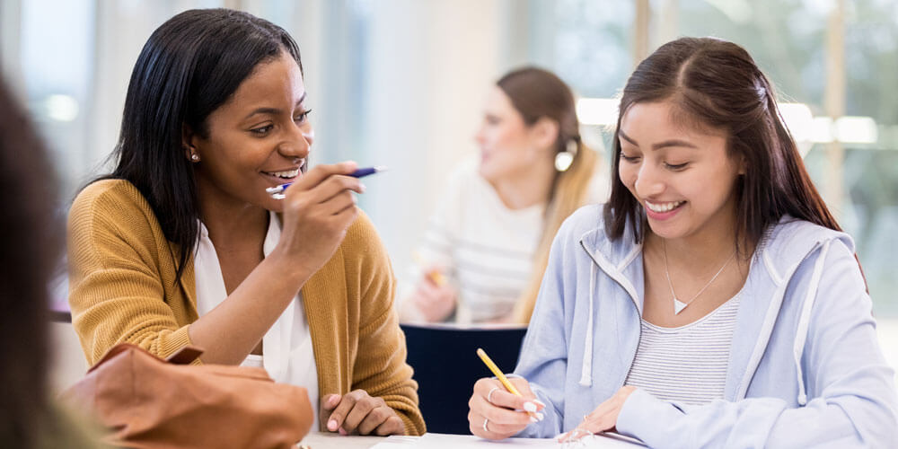 Tutor and student smiling together