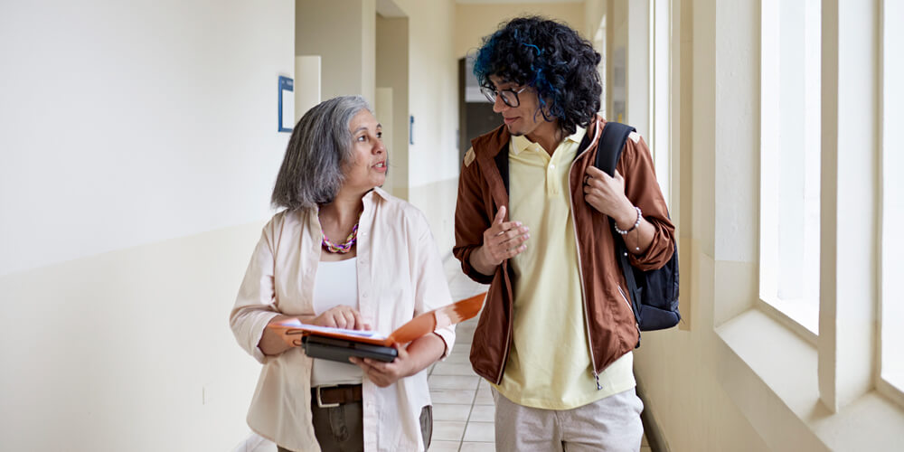 Student and professor walk while talking