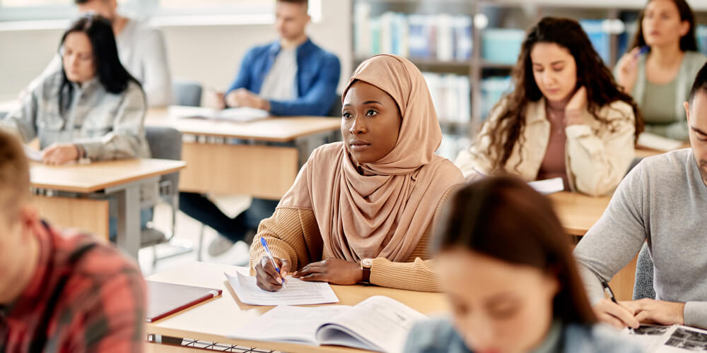 Student taking notes in classroom