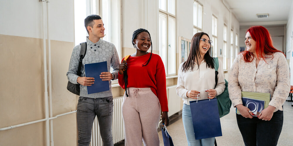 Students walk down university hallway